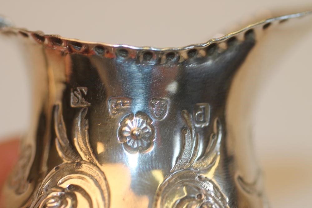 A GEORGE III SILVER CREAM JUG Image