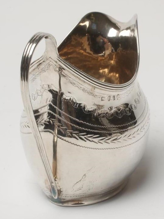 A GEORGE III SILVER MILK JUG Image