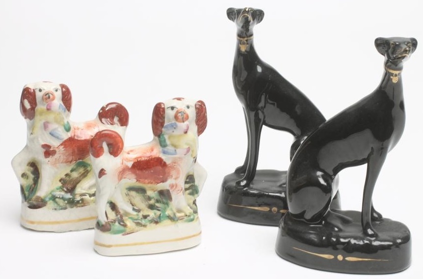 A PAIR OF VICTORIAN BLACK GLAZED STAFFORDSHIRE POTTERY GREYHOUNDS with free standing fore-legs Image