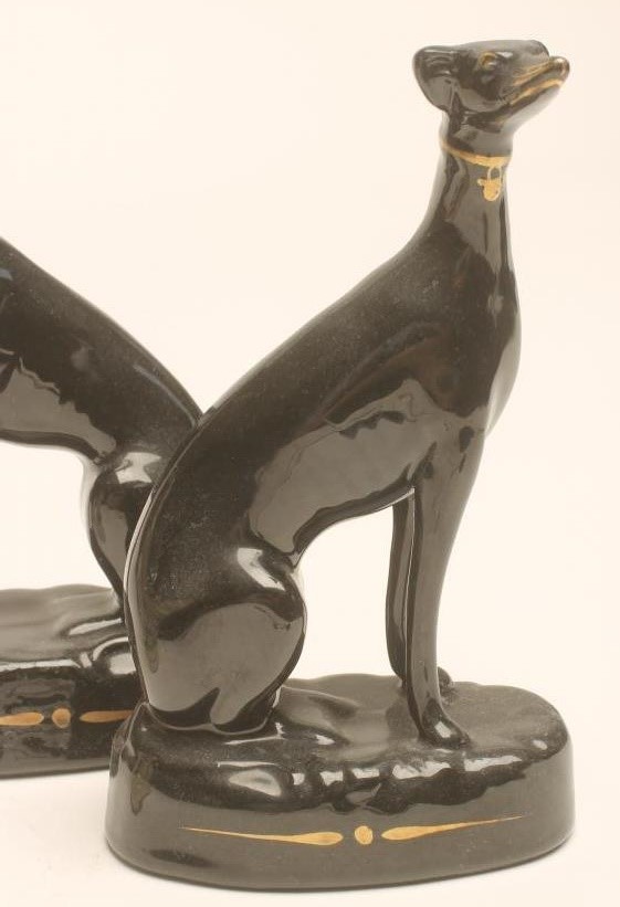 A PAIR OF VICTORIAN BLACK GLAZED STAFFORDSHIRE POTTERY GREYHOUNDS with free standing fore-legs Image