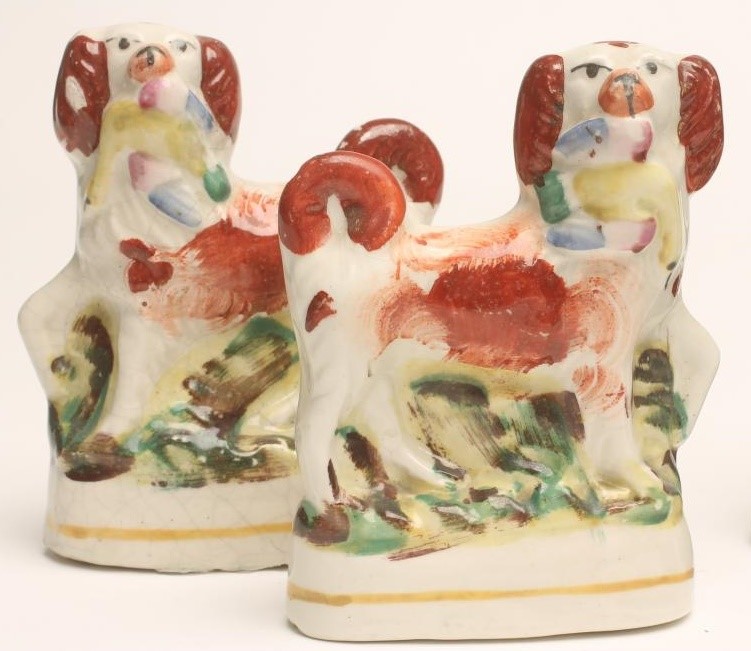 A PAIR OF VICTORIAN BLACK GLAZED STAFFORDSHIRE POTTERY GREYHOUNDS with free standing fore-legs Image