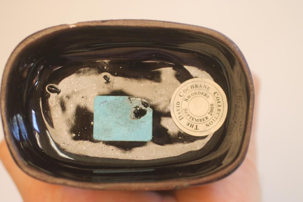 A PAIR OF VICTORIAN BLACK GLAZED STAFFORDSHIRE POTTERY CATS Image