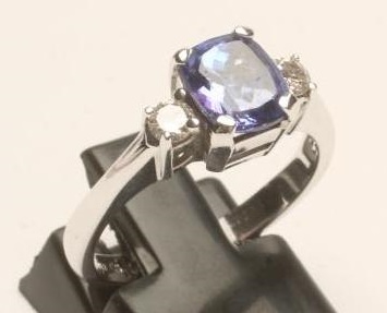 A TANZANITE AND DIAMOND THREE STONE RING Image