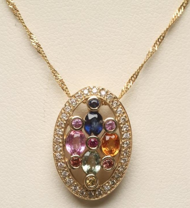 A MULTI-GEM SET PENDANT of oval form Image