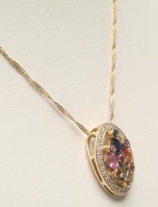A MULTI-GEM SET PENDANT of oval form Image