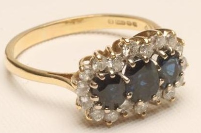 A SAPPHIRE AND DIAMOND TRIPLE CLUSTER RING Image
