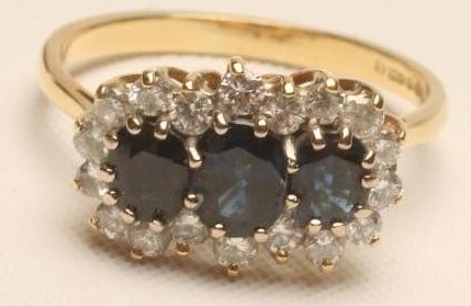 A SAPPHIRE AND DIAMOND TRIPLE CLUSTER RING Image