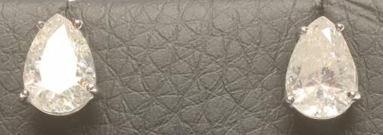 A PAIR OF SOLITAIRE DIAMOND EAR STUDS Image