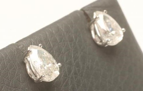 A PAIR OF SOLITAIRE DIAMOND EAR STUDS Image