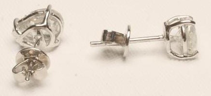 A PAIR OF SOLITAIRE DIAMOND EAR STUDS Image