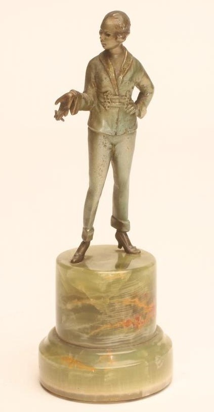 AN ART DECO COLD PAINTED SPELTER SMALL FIGURE of a fashionable young lady with shingled hair Image