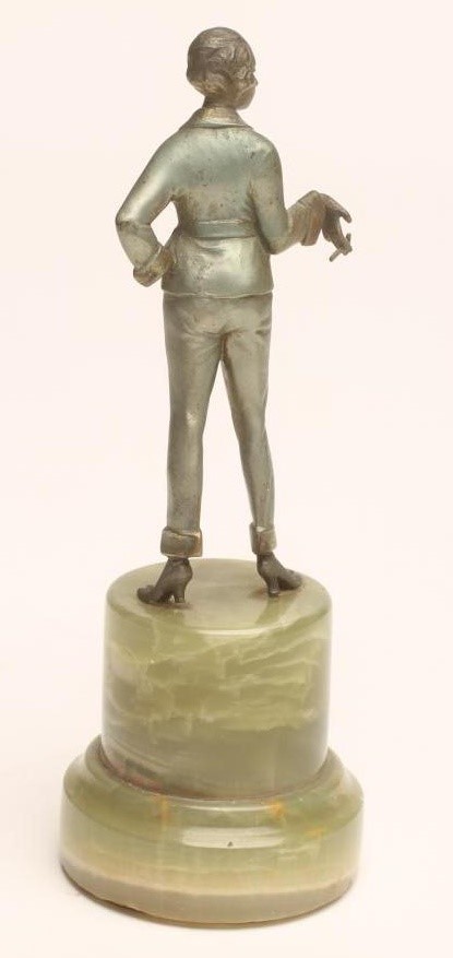 AN ART DECO COLD PAINTED SPELTER SMALL FIGURE of a fashionable young lady with shingled hair Image