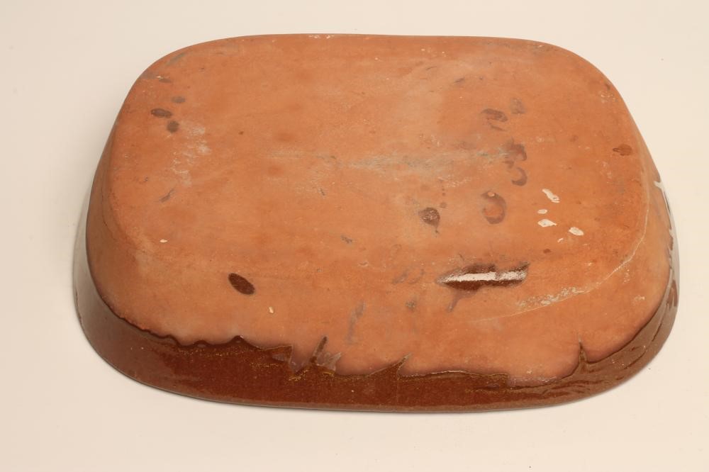 A LARGE SLIPWARE BAKING DISH of plain rounded oblong form with cream slip feathered border Image