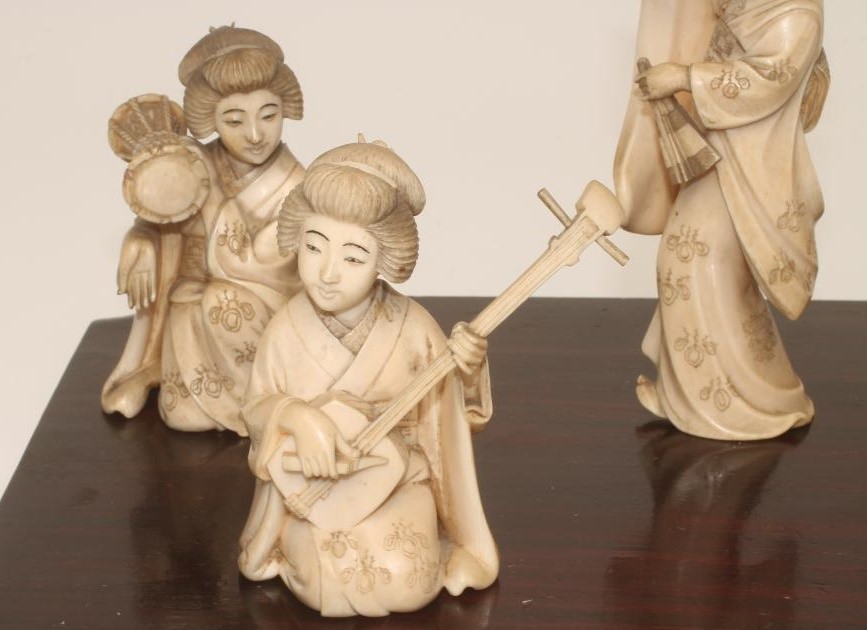 A COLLECTION OF JAPANESE IVORY FEMALE MUSICIANS AND FAN DANCER Image