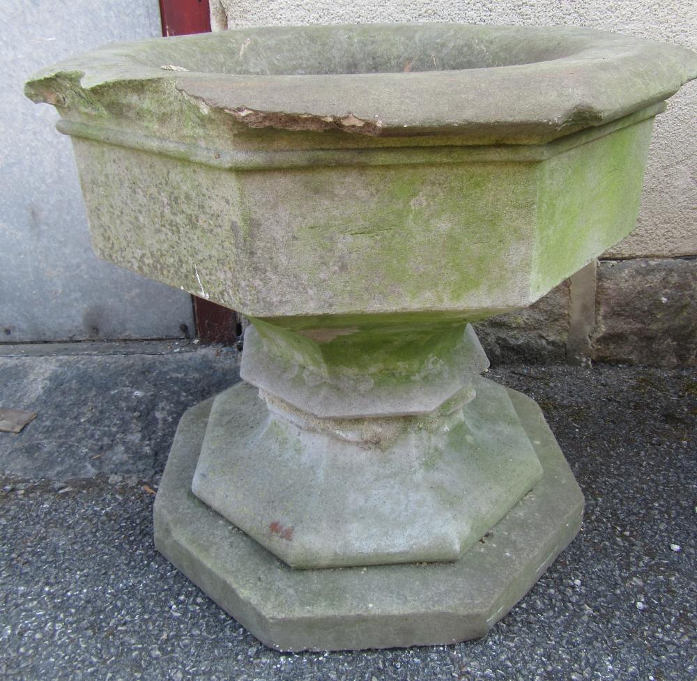 A SANDSTONE URN of octagonal form with lipped rim tapering body and spreading base Image