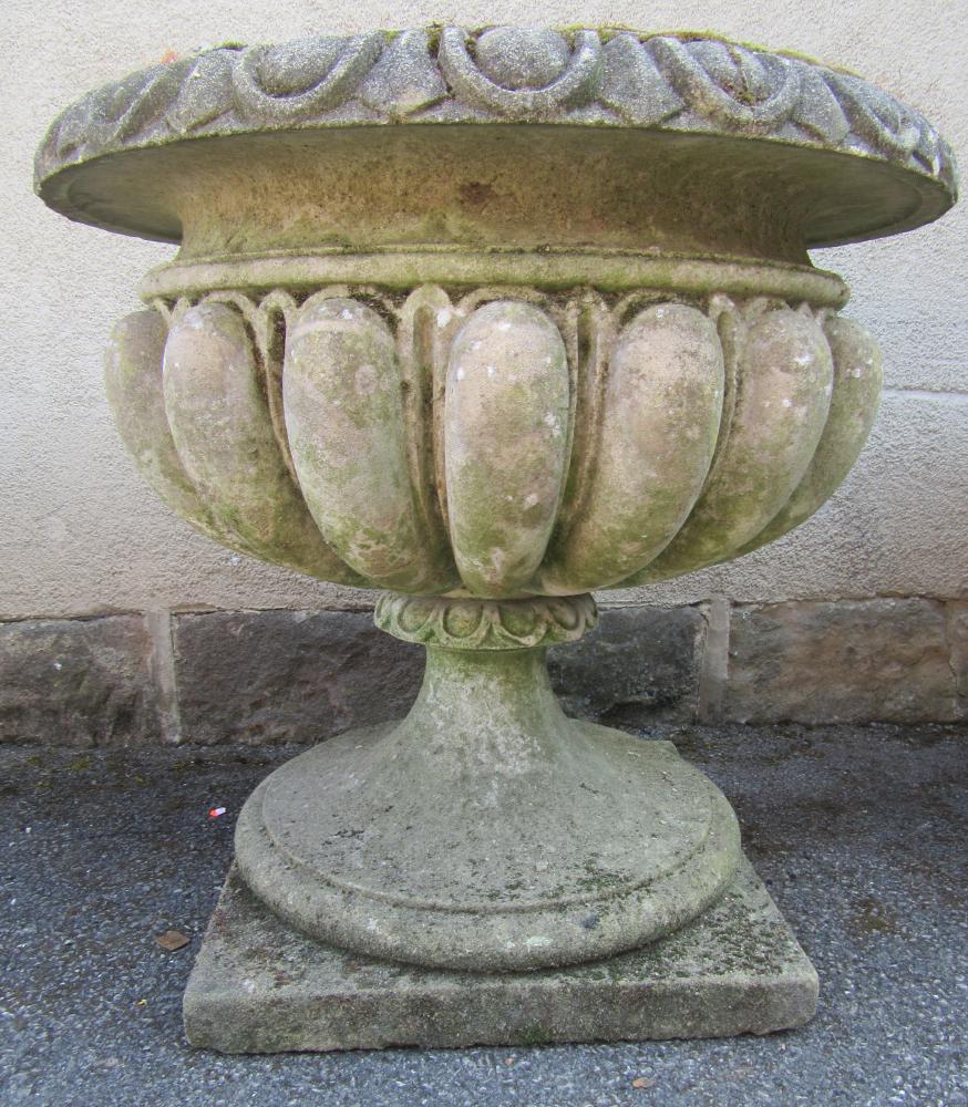 A COMPOSITION STONE URN with ovolo moulded rim Image