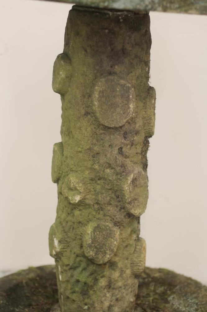 A SANDSTONE BIRD BATH of rough hewn circular form Image