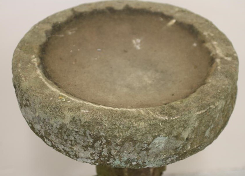 A SANDSTONE BIRD BATH of rough hewn circular form Image