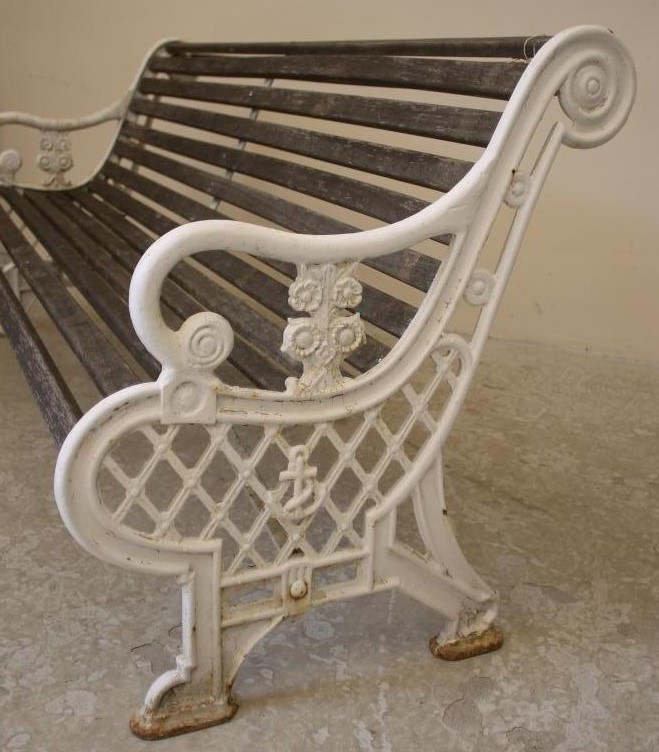 A VICTORIAN CAST IRON GARDEN BENCH with slatted wood seat and back Image