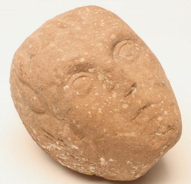 A CARVED RED SANDSTONE HEAD OF A YOUNG MAN Image