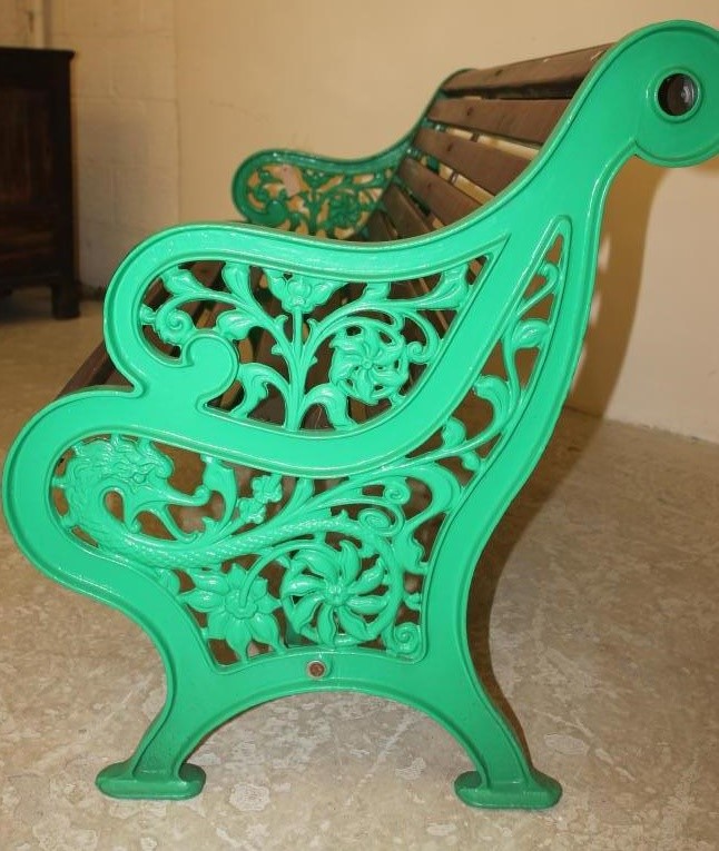 A VICTORIAN CAST IRON GARDEN BENCH with mahogany slatted seat and back Image