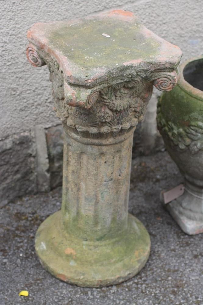 A VICTORIAN TERRACOTTA URN of ovoid form with floral swags suspended from lug handles Image