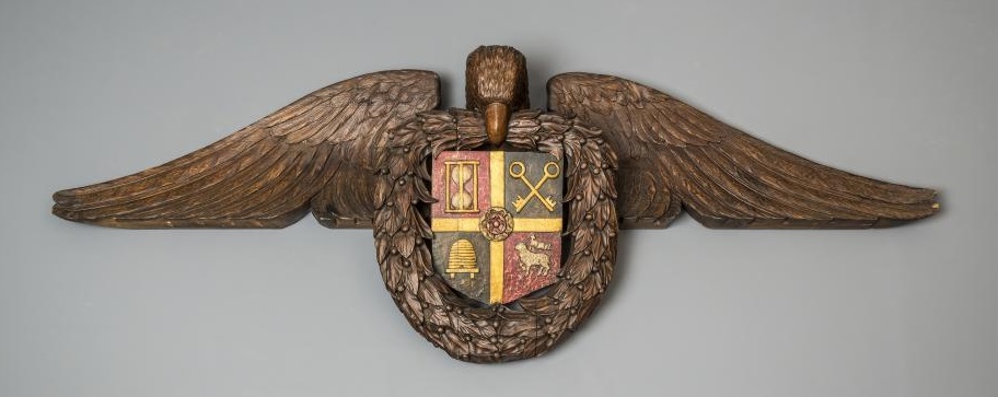 A CARVED AND STAINED WOOD SURMOUNT Image