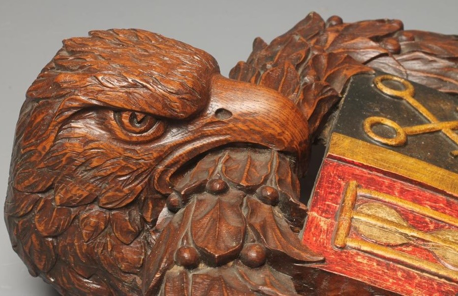 A CARVED AND STAINED WOOD SURMOUNT Image