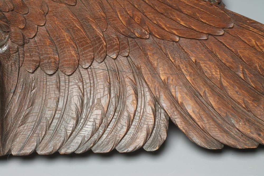 A CARVED AND STAINED WOOD SURMOUNT Image