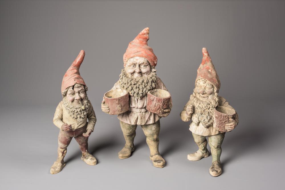 A VICTORIAN TERRACOTTA GARDEN GNOME modelled standing with red cap Image