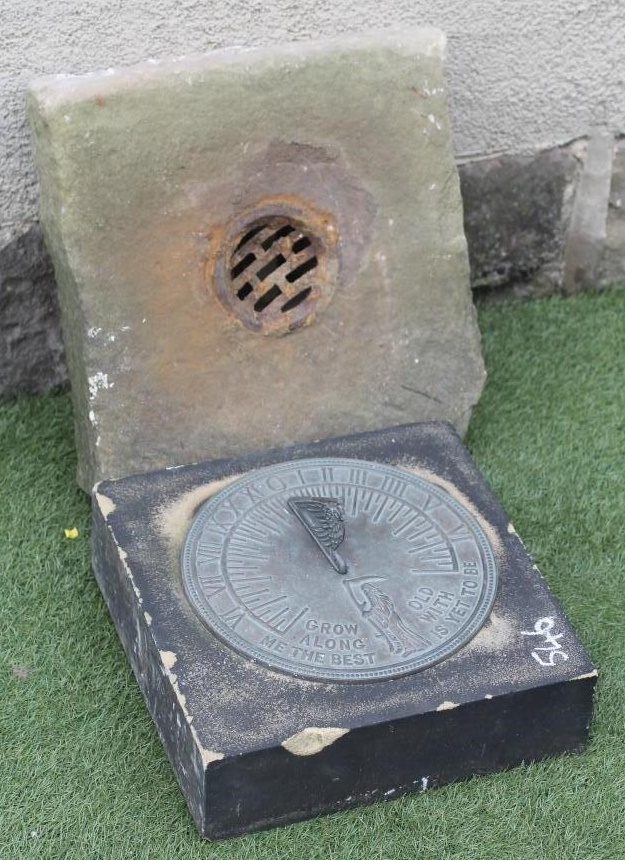 A SANDSTONE BLOCK of square form with modern bronzed sundial Image