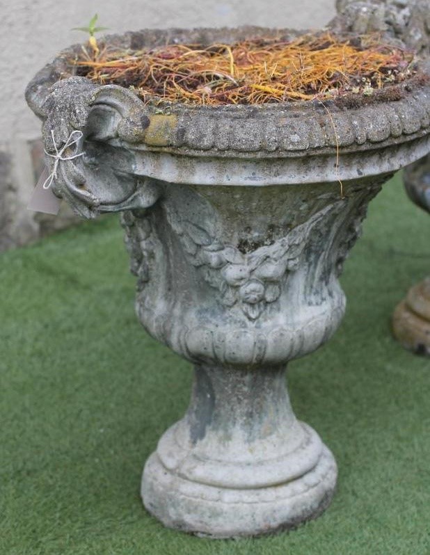A PAIR OF COMPOSITION STONE URNS of half fluted campana form with fruit swags and acanthus sheathed Image
