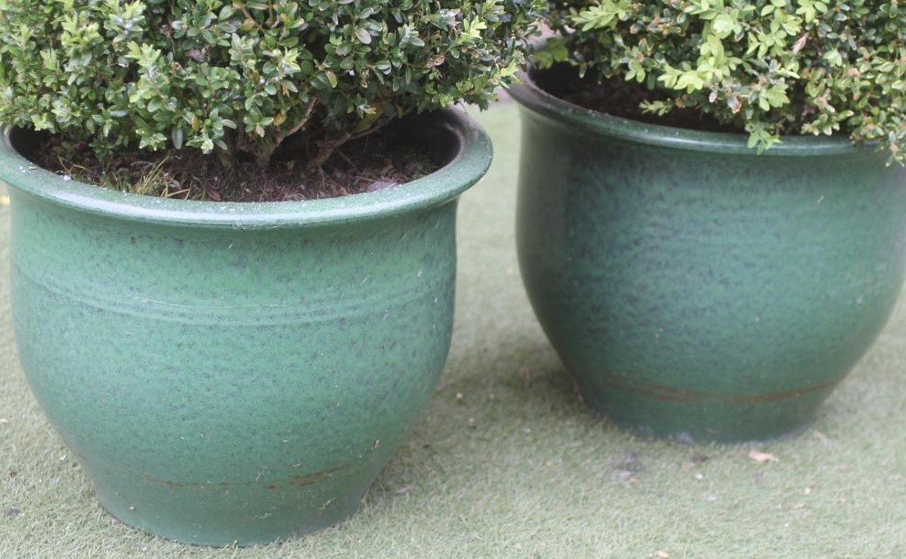 A PAIR OF GREEN GLAZED POTTERY FLOWER POTS Image
