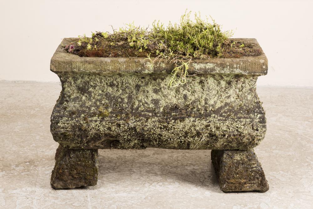 A SANDSTONE TROUGH of oblong form with ogee sides and cut corner well Image