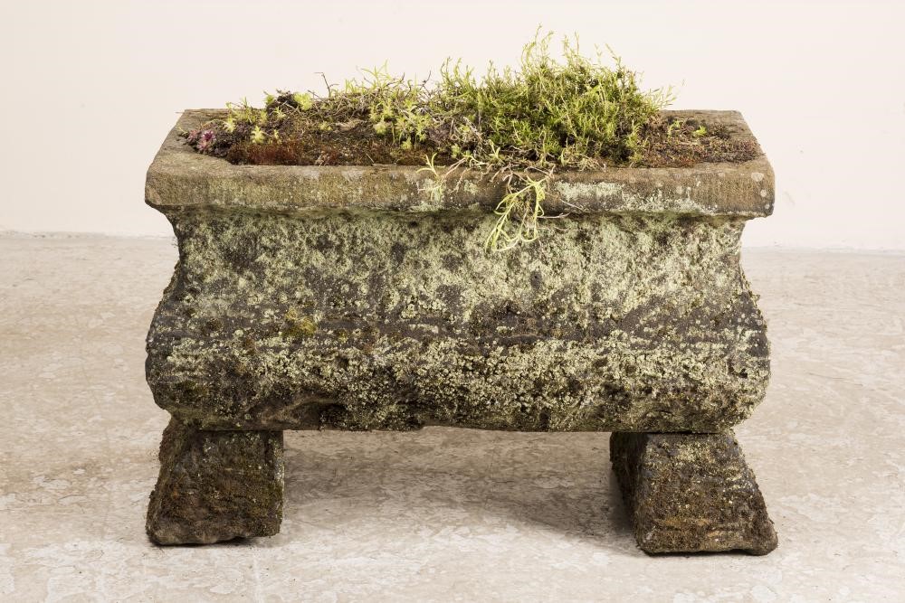 A SANDSTONE TROUGH of oblong form with ogee sides and cut corner well Image