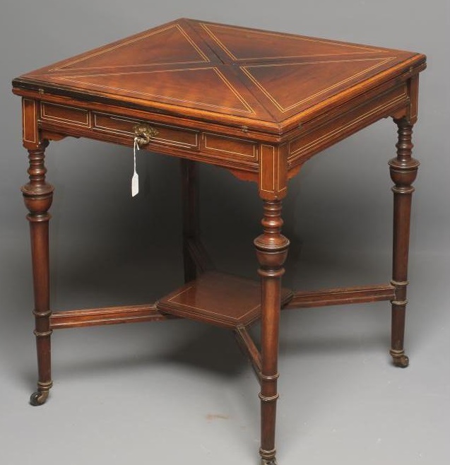 A LATE VICTORIAN ROSEWOOD ENVELOPE CARD TABLE of usual form with stringing Image