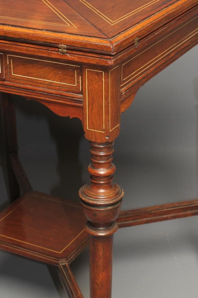 A LATE VICTORIAN ROSEWOOD ENVELOPE CARD TABLE of usual form with stringing Image