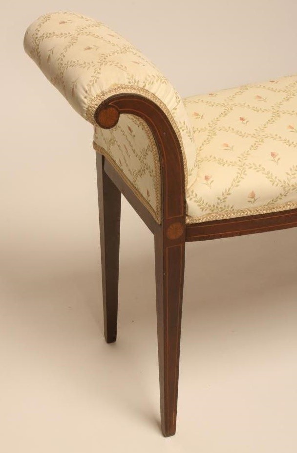 AN EDWARDIAN MAHOGANY WINDOW SEAT of mildly bowed form with stringing and marquetry roundels Image