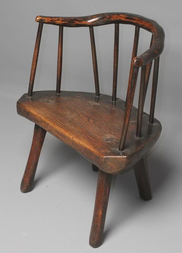 A PRIMITIVE ASH AND ELM STICK BACK ELBOW CHAIR with arched rustic top rail Image