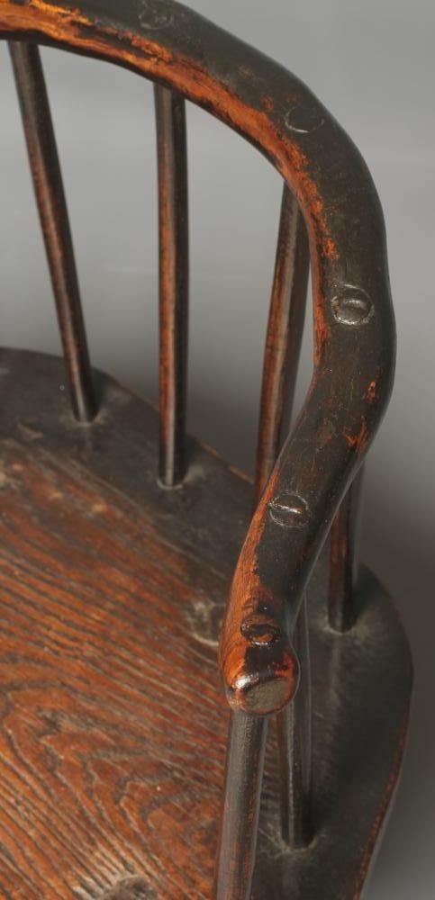 A PRIMITIVE ASH AND ELM STICK BACK ELBOW CHAIR with arched rustic top rail Image