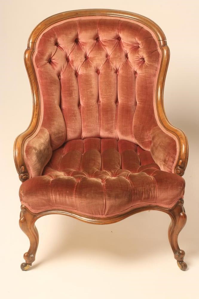 A LADY'S VICTORIAN WALNUT FRAMED ARMCHAIR of low spoonback form button upholstered in pink velvet Image