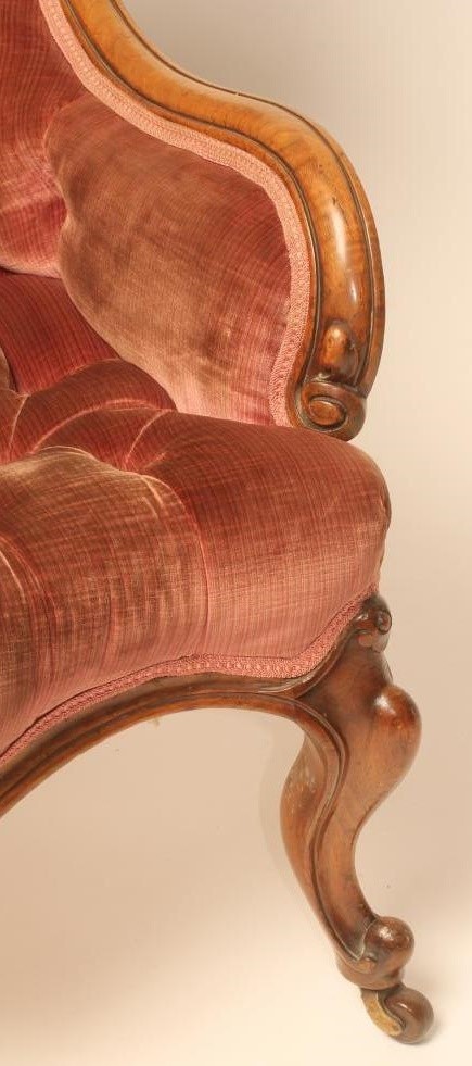 A LADY'S VICTORIAN WALNUT FRAMED ARMCHAIR of low spoonback form button upholstered in pink velvet Image