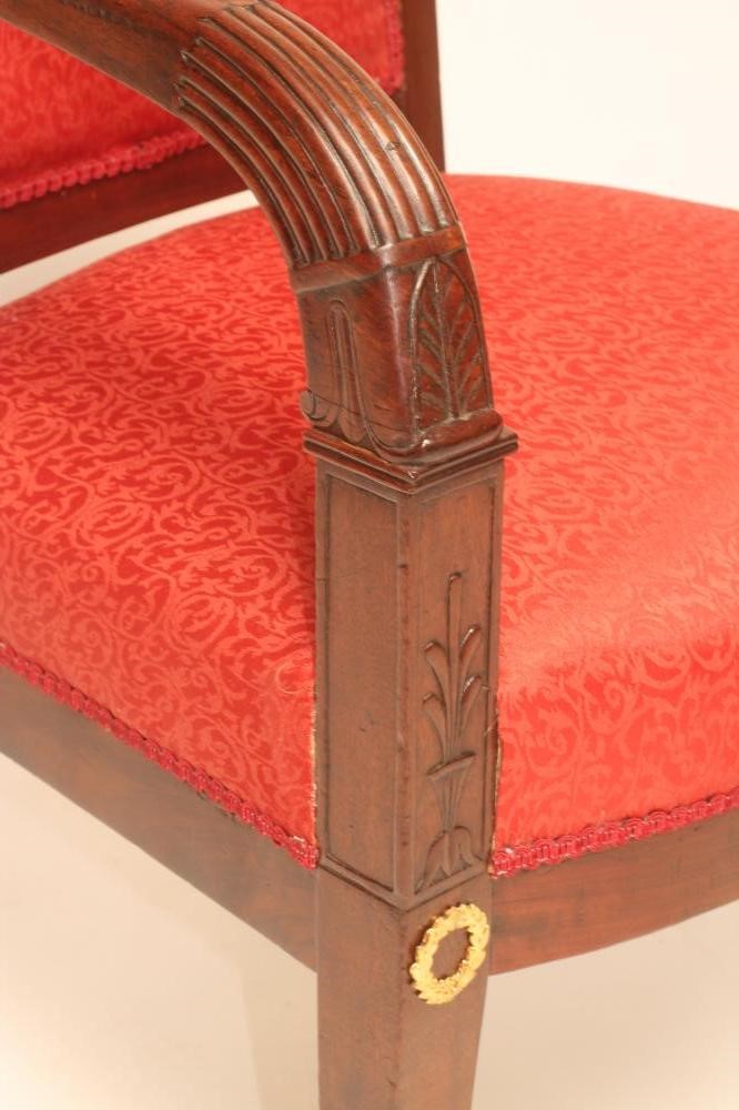 A FRENCH EMPIRE MAHOGANY ARMCHAIR with gilt metal mounts upholstered in red silk Image