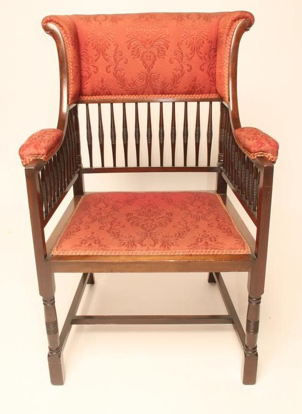 AN AESTHETIC MAHOGANY FRAMED WING ELBOW CHAIR upholstered in a red weave Image