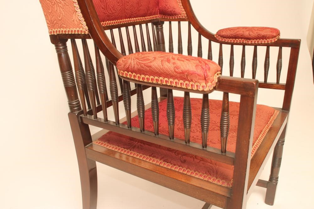AN AESTHETIC MAHOGANY FRAMED WING ELBOW CHAIR upholstered in a red weave Image