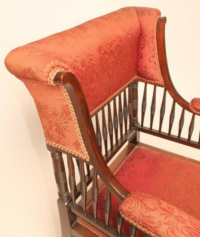 AN AESTHETIC MAHOGANY FRAMED WING ELBOW CHAIR upholstered in a red weave Image