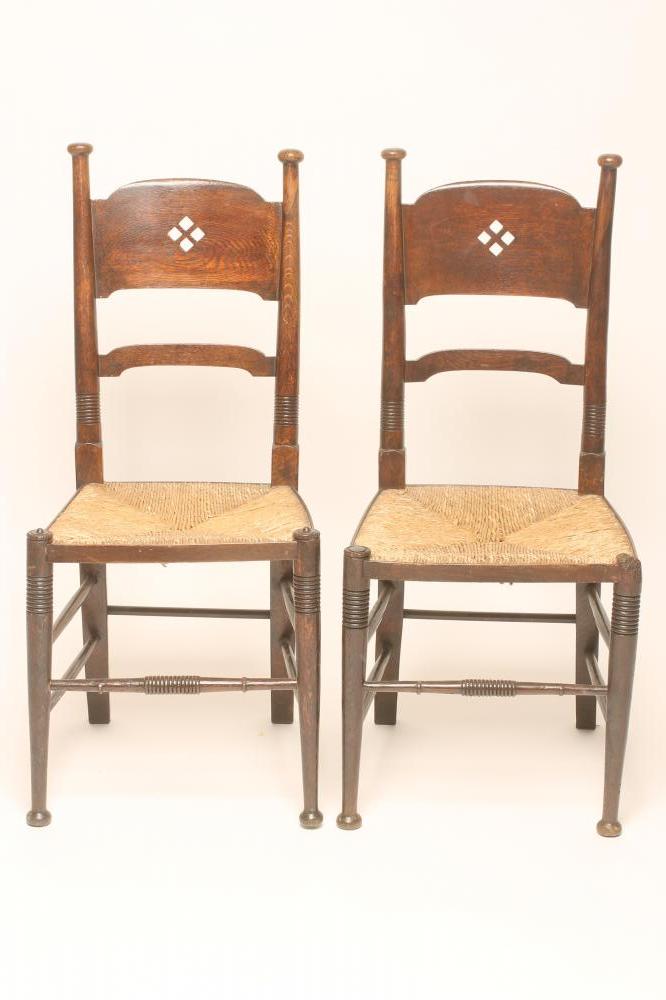 A MATCHED PAIR OF WILLIAM BIRCH ARTS AND CRAFTS OAK CHAIRS Image