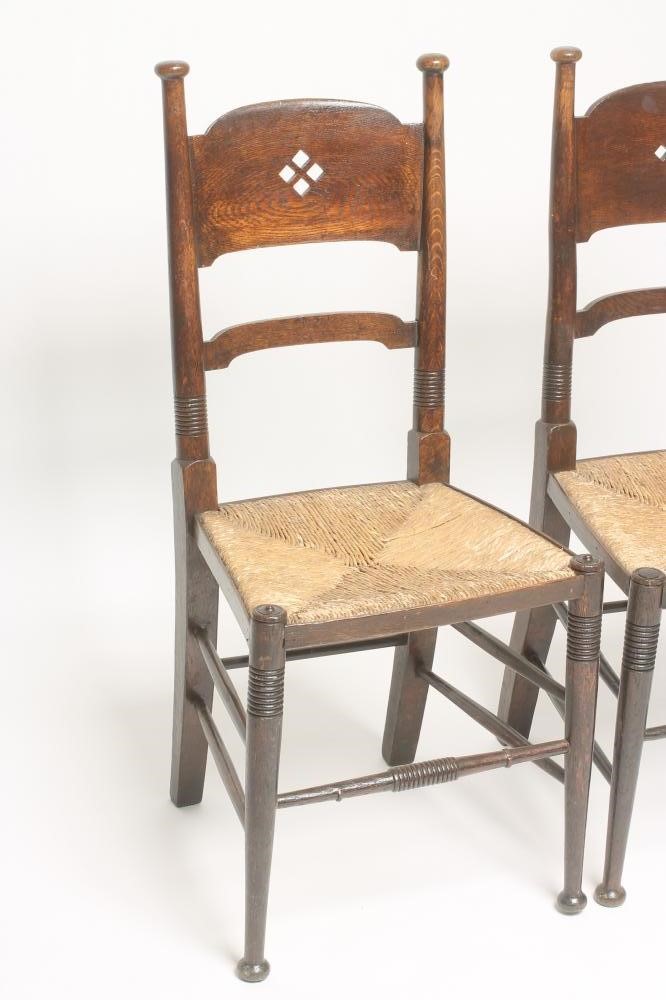 A MATCHED PAIR OF WILLIAM BIRCH ARTS AND CRAFTS OAK CHAIRS Image