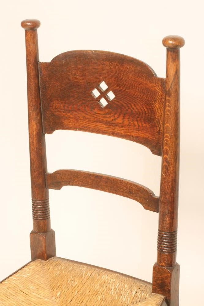 A MATCHED PAIR OF WILLIAM BIRCH ARTS AND CRAFTS OAK CHAIRS Image
