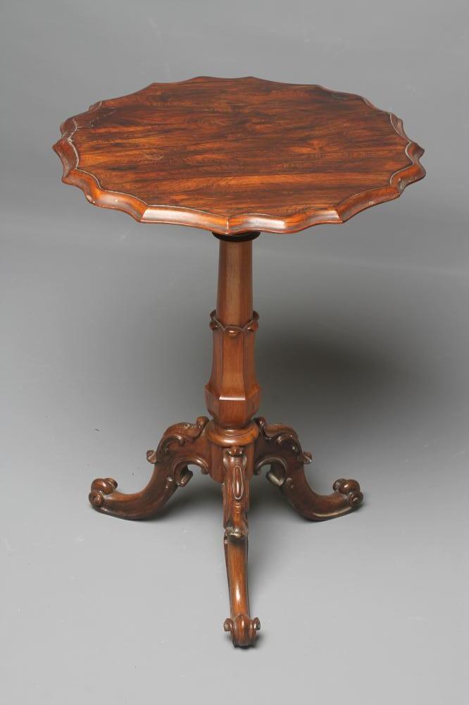 A VICTORIAN ROSEWOOD LAMP TABLE of circular form with moulded wavy edged top Image